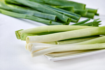 White background, green onions, vegetables.