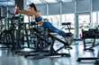 © nazarovsergey - Girl working out on hyperextension machine with weight plate at gym