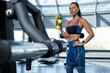 © nazarovsergey - Girl drinking water from bottle during training at gym