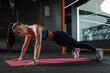 © nazarovsergey - Woman performing front plank on straight arms at gym