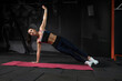 © nazarovsergey - Sporty woman doing side plank during workout at gym