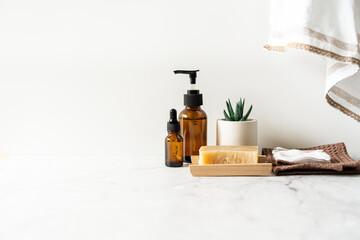 Natural bathroom and home spa tools. Zero waste sustainable lifestyle concept. Bamboo toothbrush, natural soap bar, cotton pads, homemade DIY beauty products in reusable bottles on white background.