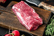 Raw fresh marbled meat black angus steak, Filet mignon tenderloin cut, on wooden cutting board, on black stone background