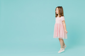 Wall Mural - Full size body length little fun cute kid girl 5-6 years old wears pink dress dancing isolated on pastel blue color background child studio portrait. Mother's Day love family people lifestyle concept.