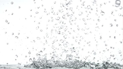 Canvas Print - Super slow motion drops of water fall on the table. On a white background.Filmed on a high-speed camera at 1000 fps. High quality FullHD footage