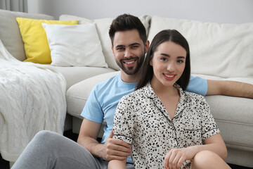 Sticker - Happy young couple in pajamas at home