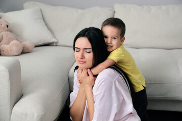 Wall Mural - Depressed single mother with child in living room