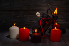 Rune Kenaz. A Composition Of Burning Candles, An Old Leather Bag For Scandinavian Runes With A Bokeh Effect.