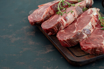 Raw beef ribeye on dark background