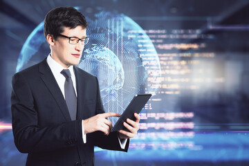 Poster - Happy businessman using tablet with abstract globe and coding interface on blurry office background. Technology and programming concept. Double exposure.