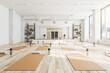 © Who is Danny - Modern concrete yoga gym interior with equipment, daylight and wooden flooring. Healthy lifestyle concept. 3D Rendering.