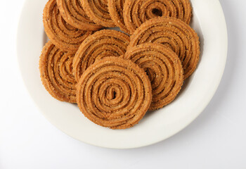 Wall Mural - Indian Traditional Tea Time Snack Chakli, a deep fried snack, It is known as Chakali, Murukku, Muruku, Murkoo, Chakri.
