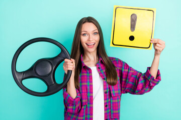 Sticker - Portrait of attractive trendy cheerful girl holding steering wheel card exclamation point isolated over bright teal color background