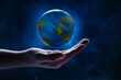 © fotokitas - Human hand holding planet earth