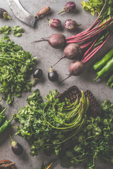 Fresh bundle of beetroot and herbs. Vegetables and vintage kitchen utensils on dark concrete background. Cooking preparation with fresh vegetables. Healthy food concept. Top view