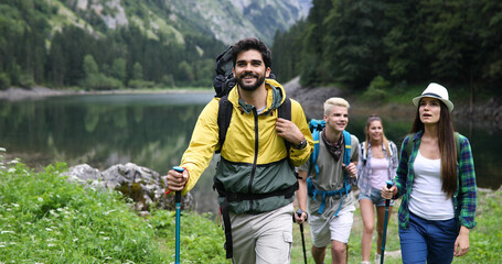 Wall Mural - group of friends on a hiking, camping trip in the mountains