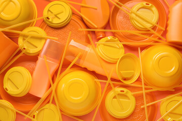 Different orange plastic items as background, closeup