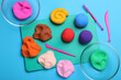 Flat lay composition with colorful plasticine on light blue background