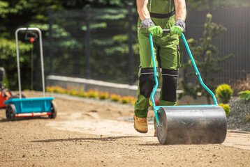 Tow Lawn Roller Pushed by Gardener