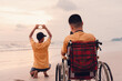 Asian special child on wheelchair on the beach with parents in family holiday to travel, Take photo the camera nature around the sea beach, Life in the education age, Happy disabled kid concept.