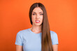 Photo of disgusted brown hairdo young lady wear blue t-shirt isolated on vivid orange color background