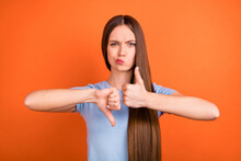 Photo Of Sad Brown Hairdo Young Lady Show Thumb Up Down Wear Blue T-shirt Isolated On Vivid Orange Color Background