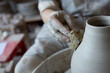 © Lydia Cazorla/Stocksy - Woman making pottery on spinning wheel in her workshop