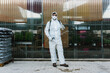 © VICTOR TORRES/Stocksy - Man wearing a professional protective coverall to fumigate plant