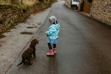 Little Girl Walking Around Little Town With Her Dog