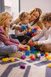 © VICTOR TORRES/Stocksy - Mother and kids playing with toys at home