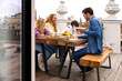 © VICTOR TORRES/Stocksy - Happy family having breakfast on terrace