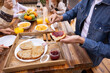 © VICTOR TORRES/Stocksy - Unrecognizable family having breakfast together on terrace