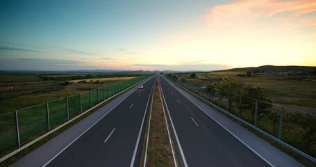 Wall Mural - Driving on open highway road, aerial sunset view