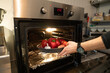 © Hernandez & Sorokina/Stocksy - Male Hand Putting Vegetables At Oven