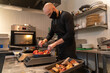 © Hernandez & Sorokina/Stocksy - Man With Mask Working At Kitchen