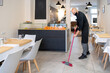© Hernandez & Sorokina/Stocksy - Worker Cleaning Restaurant Floor
