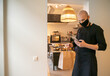 © Hernandez & Sorokina/Stocksy - Chef Checking Cellphone At Kitchen