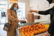 © Hernandez & Sorokina/Stocksy - Client Paying For Take Away Order