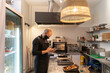 © Hernandez & Sorokina/Stocksy - Chef Using Cellphone At Kitchen