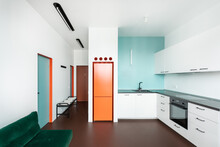 Minimalist Living Room / Kitchen With Blue, Green And Orange Elements