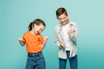 excited kids with closed eyes rejoicing isolated on blue.