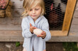 © Jennifer Bogle/Stocksy - Girl holds fresh egg