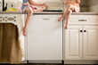 © Jennifer Bogle/Stocksy - Girls perch on counter filling muffin tin