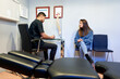 © Guille Faingold/Stocksy - Doctor and client speaking in medical office