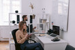 © Oleksii Syrotkin/Stocksy - Serious female trader working on laptop in office