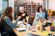 © Guille Faingold/Stocksy - Colleagues having lunch during business meeting