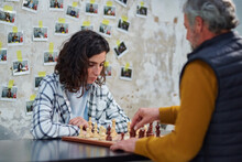 Players At Chessboard