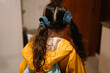 © Eloisa Ramos/Stocksy - kid from back ready to go to school with two scrunchies