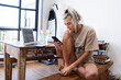 © Helene Cyr/Stocksy - Woman looking at her phone