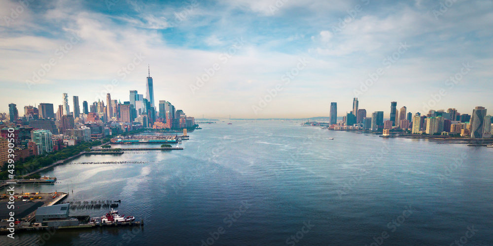 New York and New Jersey separated with Hudson river and Manhatn skyline rising above aerial view - obrazy, fototapety, plakaty 